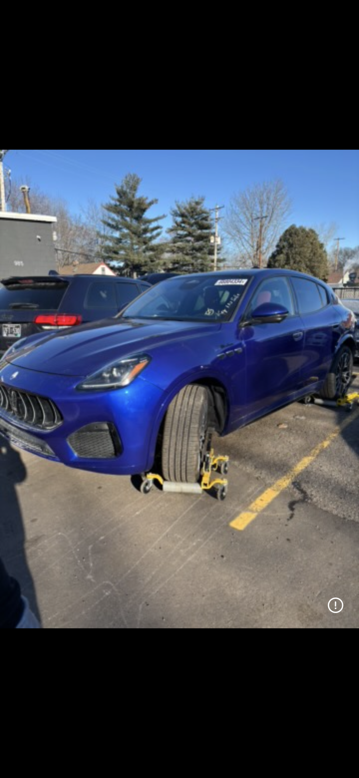 Blue Maserati towing service Wizards Recovery